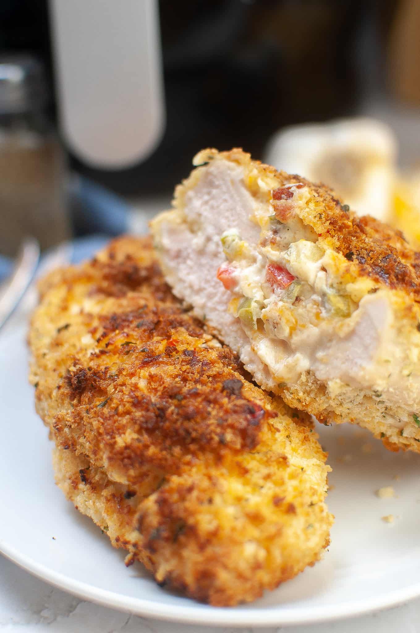 Stuffed chicken breast, one cut in half so you can see the inside. 