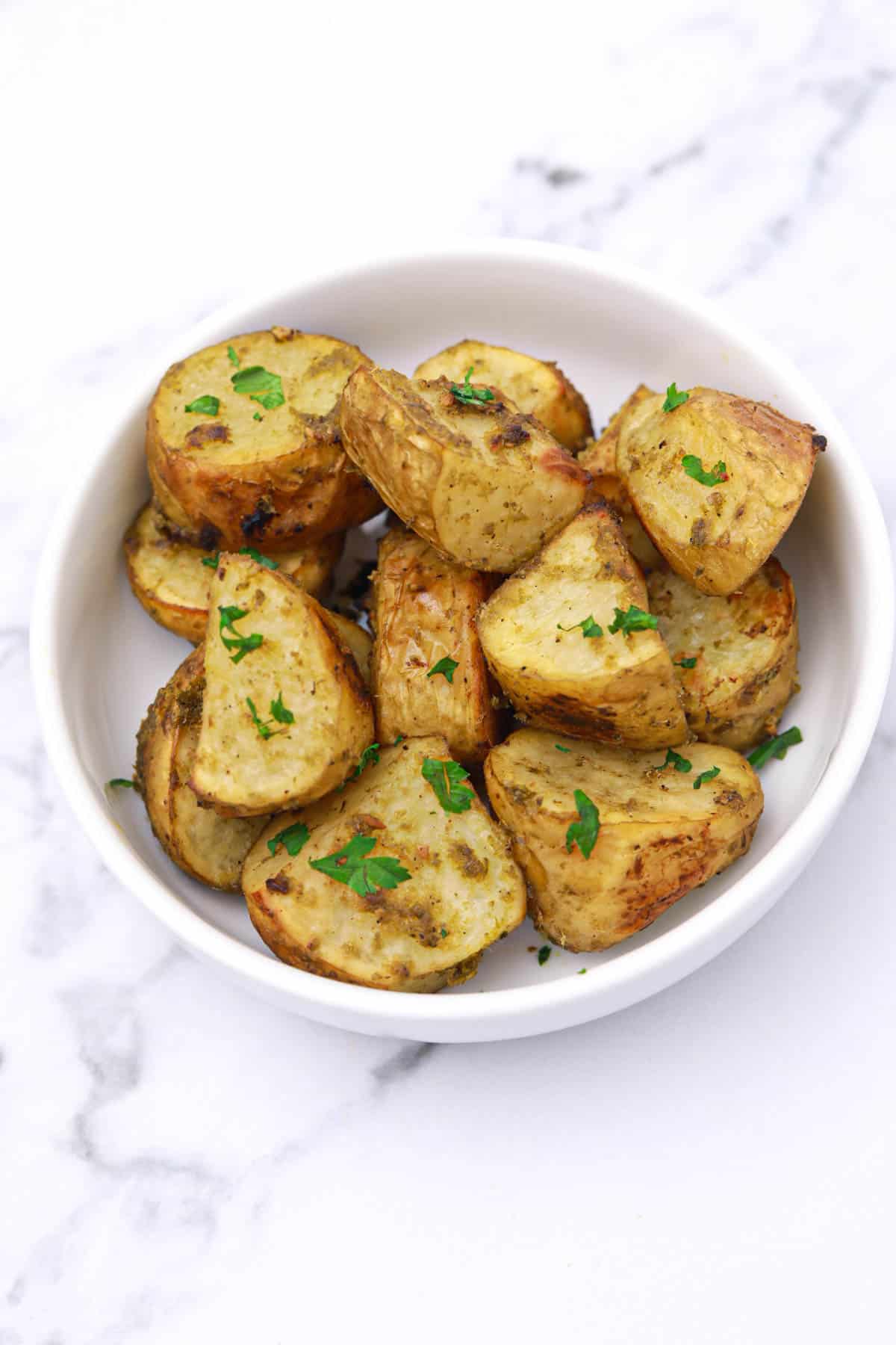 pesto potatoes garnished with parsley.