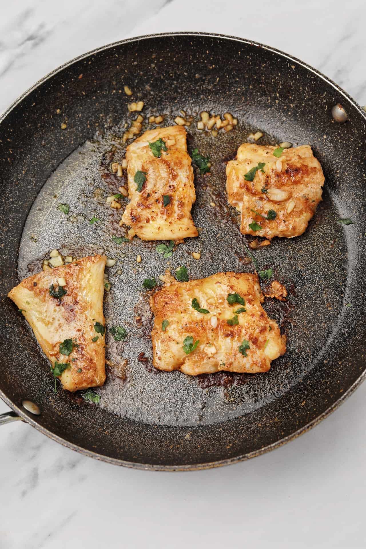 The fillets in a pan garnished with parsley.