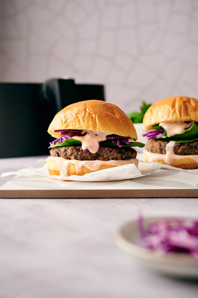 Two black bean burgers made in the air fryer ready to eat.