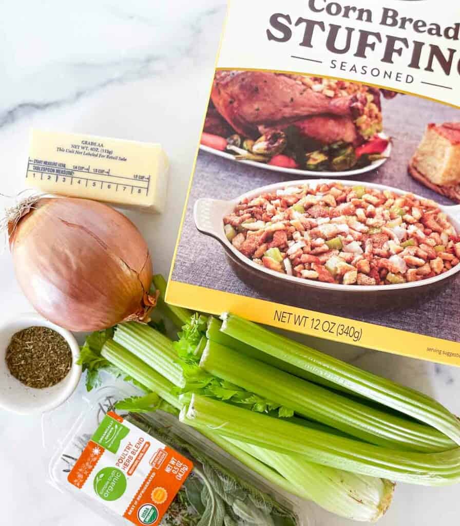 Corn bread stuffing ingredients on a marble countertop.